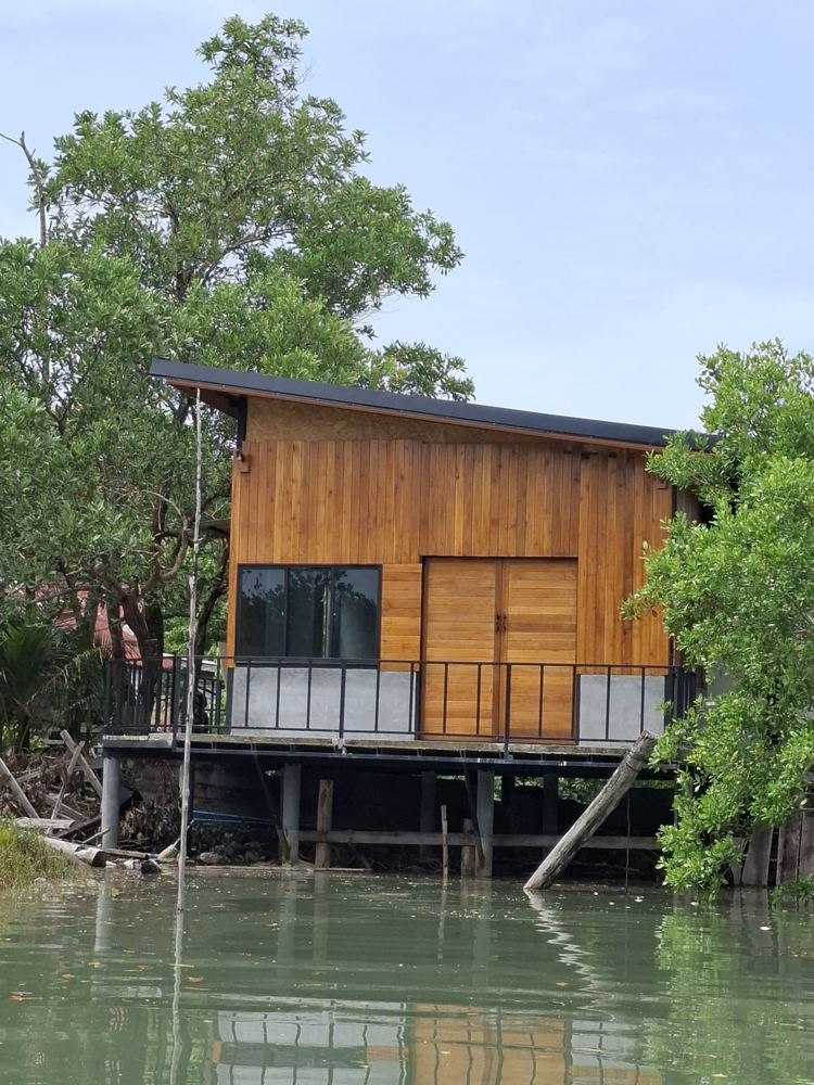 Teak house on stilts over the canal