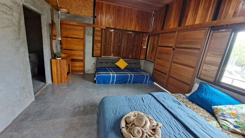 Spacious room with several beds and a bathroom